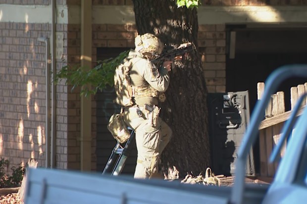 Heavily armed officers have surrounded the south-west Sydney apartment block.