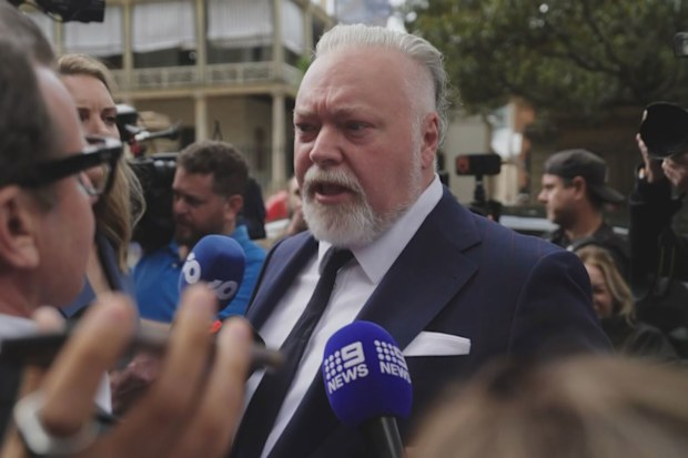 Kyle Sandilands was mobbed by reporters outside of court.