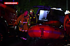 Authorities say the driver was rescued by being pulled from his vehicle by his hair.