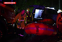 Authorities say the driver was rescued by being pulled from his vehicle by his hair.