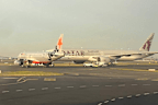 A Jetstar and a Qatar Airways plane came within metres of colliding on the tarmac at Sydney Airport.