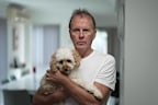 Scott with his two-year-old cavoodle Rosie.