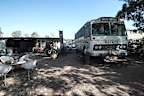 The couple remain trapped living in the bus while their unfinished $700,000 colonial farmhouse sits abandoned.