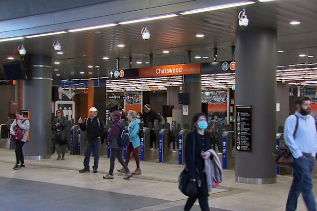 Commuters in Chatwood train station, in Sydney, begin their work commute as capacity is slashed on the city's trains, buses and ferries.