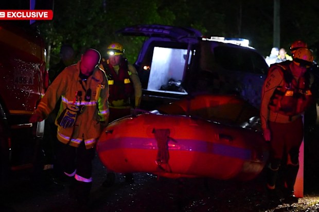 Authorities say the driver was rescued by being pulled from his vehicle by his hair.