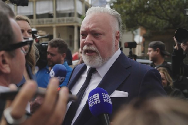 Kyle Sandilands was mobbed by reporters outside of court.