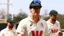 Pat Cummins leads the Australian team off the field.