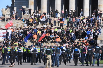 Protesters remain on the steps of the Shrine.
