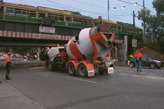 Trams running over Montague Street bridge were briefly halted on Wednesday after a cement mixer crashed into  the notoriously low South Melbourne structure.
