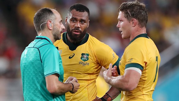 Referee Romain Poite speaks with Samu Kerevi and Wallabies captain Michael Hooper. 