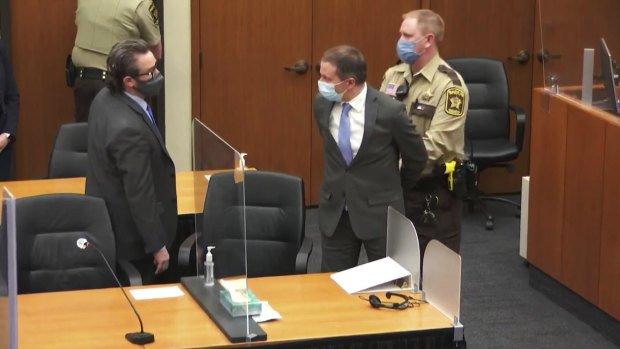 Former Minneapolis police Officer Derek Chauvin is taken into custody as his lawyer, Eric Nelson, left, looks on, after the verdicts were read.