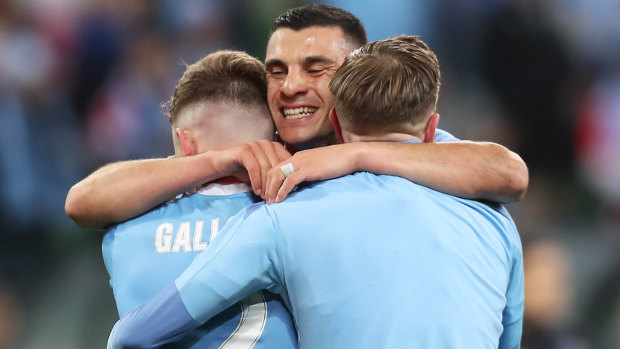 Andrew Nabbout celebrates with his City teammates Scott Galloway and Craig Noone at the stroke of full-time.