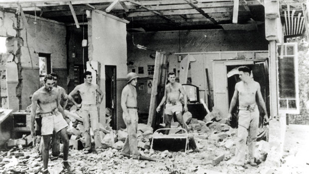 Troops inspect the remains of a building following a raid on Darwin in February, 1942.