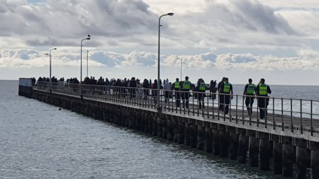 People lining the Rye Pier over the June long weekend to fish for spider crabs. 