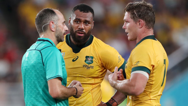 Referee Romain Poite speaks with Samu Kerevi and Wallabies captain Michael Hooper. 