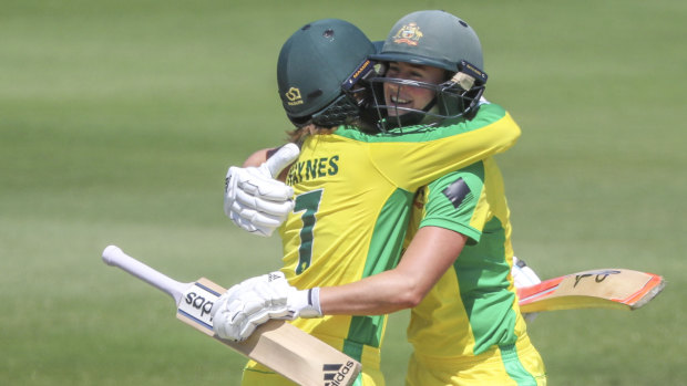 Rachael Haynes and Ellyse Perry celebrate the former's milestone - her first century in any form of the game.