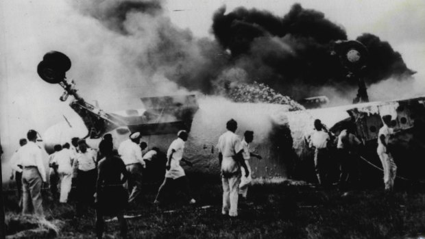 "The burning fuselage of the Qantas BOAC Constellation which burst into flames upon landing at Singapore's Kallang Airport today." March 13, 1954
