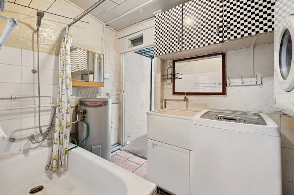 The combined bathroom and laundry at 8 Flora Street leads onto the backyard.