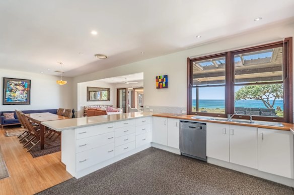 There is an open-plan living and dining zone, with beach views from the kitchen.