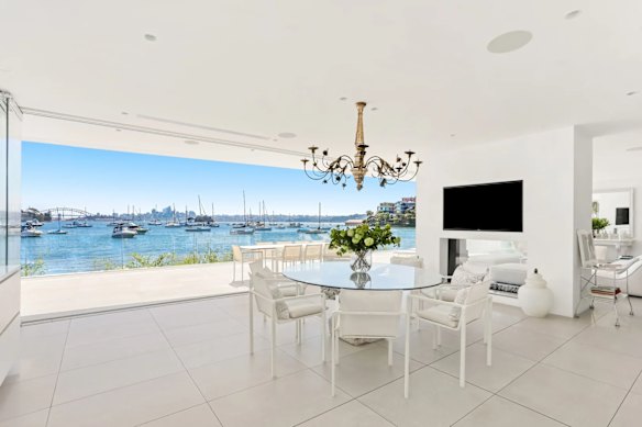 There is an all-white palette, glass stacker doors and unobstructed Harbour Bridge views from various rooms including the galley-style kitchen.