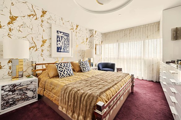Natale transformed the apartment, and it now has a bold and glamorous palette with marble wallpaper, among other materials.