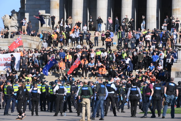 Protesters face-off with police on the steps of the Shrine of Remembrance.