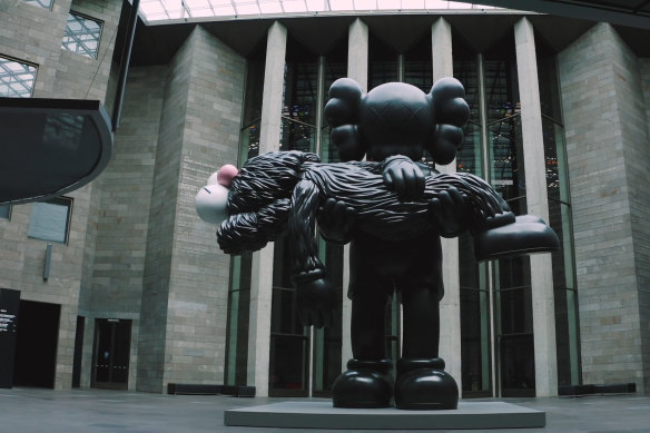 KAWS' monumental sculpture <i>Gone</i>, a lonely sentry in the empty NGV.