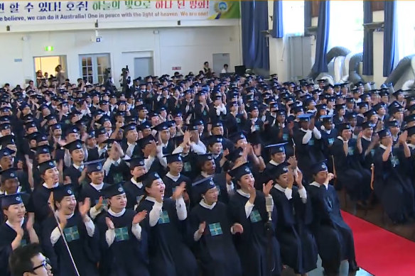 Hundreds of students at their "passover" in Australia last year, where they cheered and applauded speakers including Lee Man-Hee.