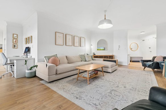 The three-bedroom apartment has two bathrooms, a double garage and a living area opening onto a private courtyard.