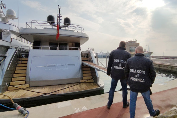 Italian Financial Police officers walk by the superyacht Lena, belonging to Gennady Timchenko, an oligarch close to Russian President Vladimir Putin, in the port of San Remo, Italy, on Saturday, March 5, 2022. 