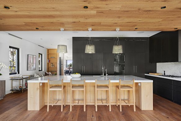The four-bedroom abode has a showpiece marble kitchen, statement pendant lighting and biophilic timber floors.