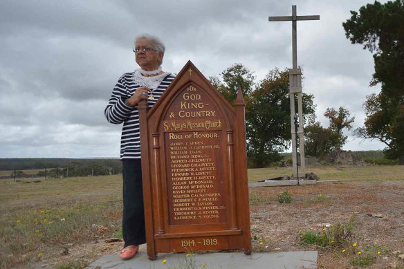 Laura Bell with the roll of honour from St Mary's church, in the ruins of the Lake Condah Mission. 