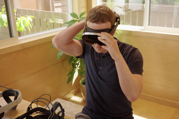 Mark Zuckerberg tries a prototype Meta headset, which uses holographic lenses to shrink complex optics into a small package. Meta said creating a consumer version would require lasers that don’t exist yet.