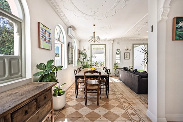The home’s aesthetic is a blend of Spanish mission and old Hollywood styles with ornate ceilings, arched windows, stencilled timber floors, an Art Deco fireplace and French doors.