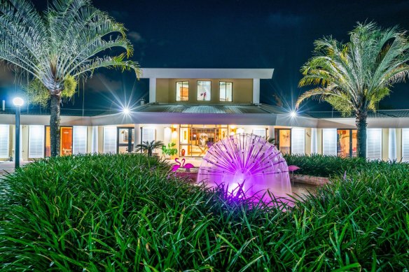 The home has a pink water feature with matching flamingoes.