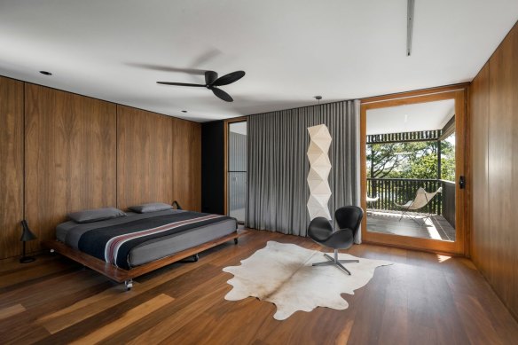 The bedroom has views of the treetops.