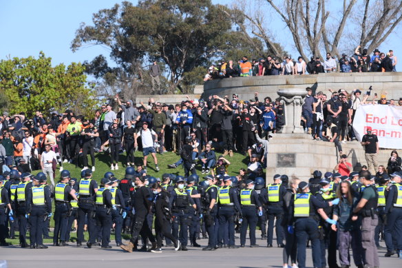 Anti-lockdown protesters face off with Victoria Police at the Shrine of Remembrance in Melbourne on Wednesday.