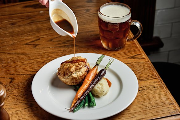Braised steak and Guinness pie with mash and roasted vegetables.