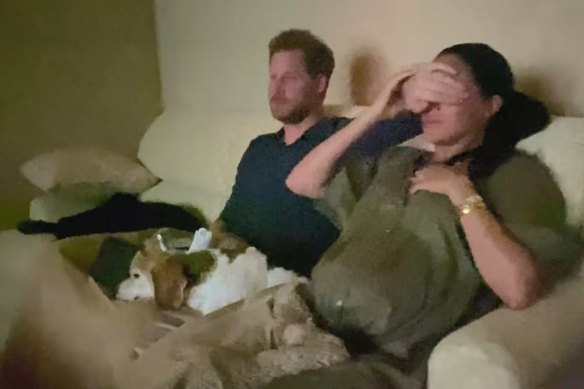 Harry covers the eyes of his wife Meghan, as they watch their interview with Oprah Winfrey.