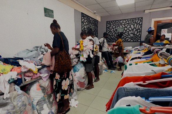 Shoppers at a “bargain bale” sale at a second-hand clothing store in Honiara, Solomon Islands.  