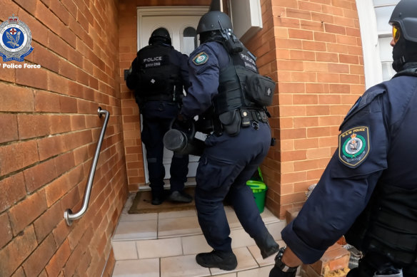 Anti-gang police storm a house in Ryde to arrest Shane Lindsay, who police allege was involved in car thefts for Sydney’s underworld.