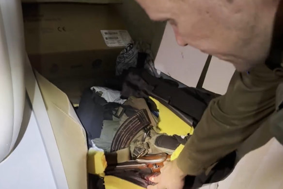 Lieutenant Colonel Jonathan Conricus shows a “grab bag” containing weapons and Hamas uniform behind an MRI machine at Al Shifa.