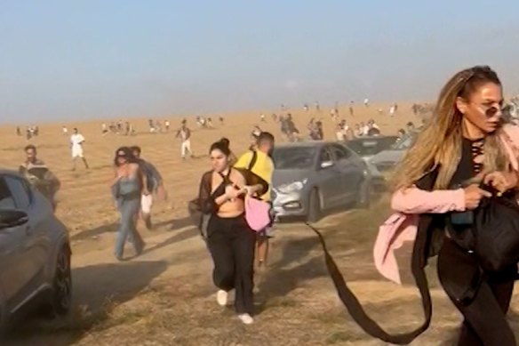 Partygoers at the Nova rave near the border with Gaza flee the gunfire. 