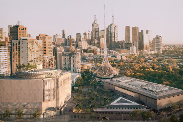 Aerial view of the winning design (left), the existing Roy Grounds building, and the city backdrop.