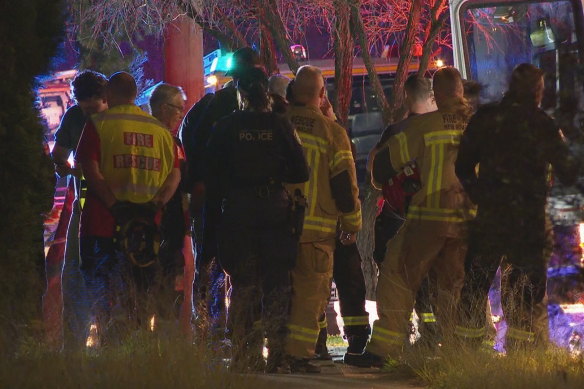 Fire and police investigators at the brick home on Freeman Street, Lalor Park.