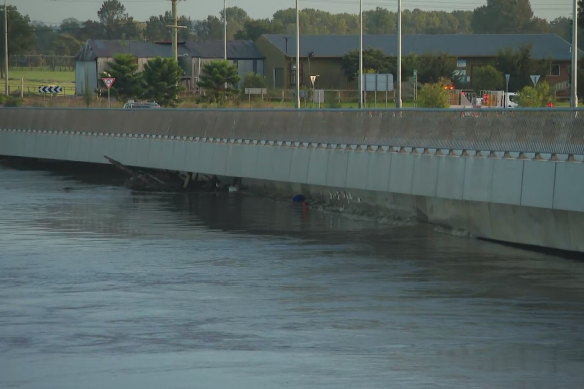 The Windsor Bridge has water lapping at its base, but has not yet gone under.