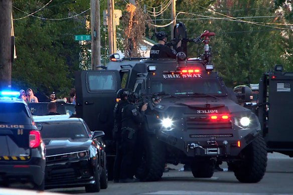 Tactical police vehicles on the scene.