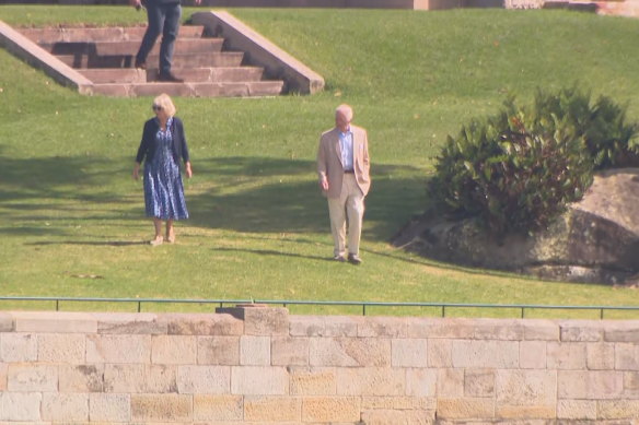 Queen Camilla and King Charles III on a walk around the grounds of Admiralty House on Saturday.
