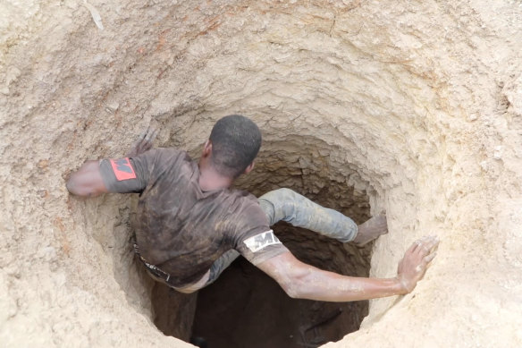 Local workers climb into a mine in Gban.