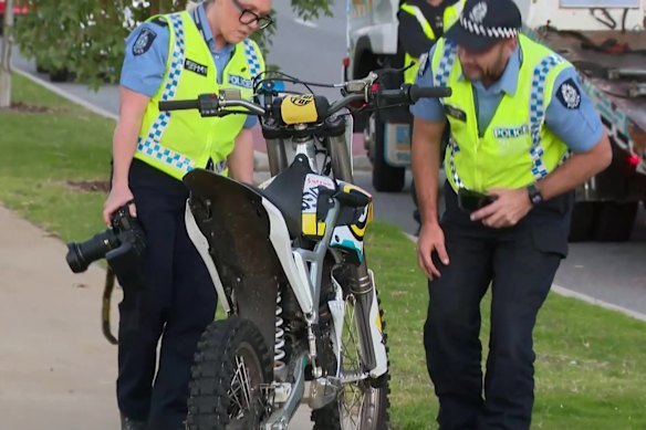 Police examine an electric off-road motorbike involved in a fatal crash in Edgewater.
